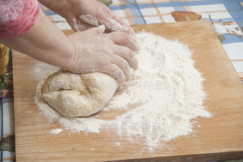 Women's hands prepairing fresh yeast dough. Raw fresh yeast dough stock images, royalty-free photos and pictures