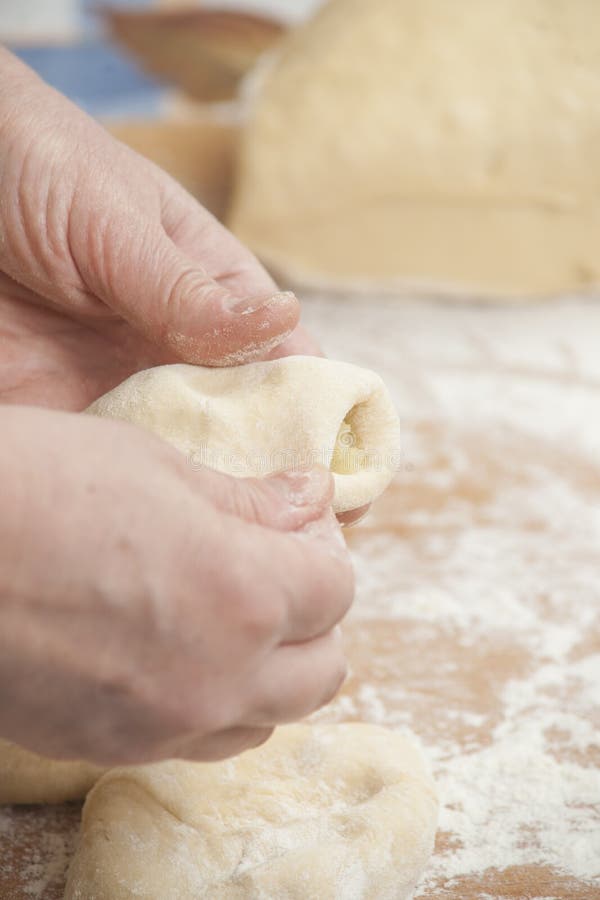 Women's hands preparing fresh yeast dough in the bowl. Raw fresh yeast dough stock images, royalty-free photos and pictures
