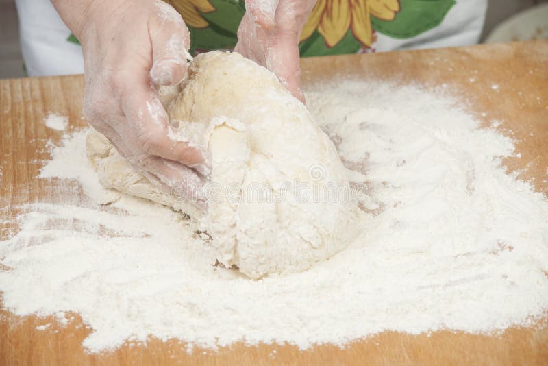 Women's hands preparing fresh yeast dough on wooden table. Raw fresh yeast dough stock images, royalty-free photos and pictures