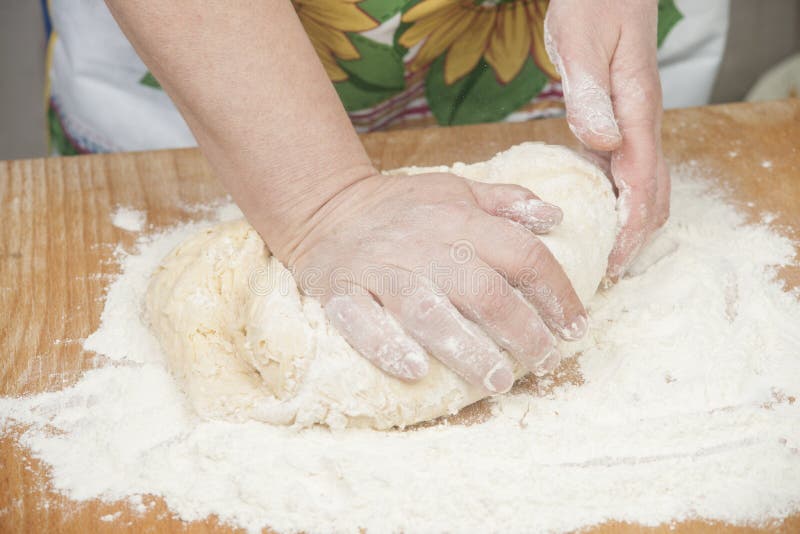 Women's hands preparing fresh yeast dough on wooden table. Raw fresh yeast dough stock images, royalty-free photos and pictures