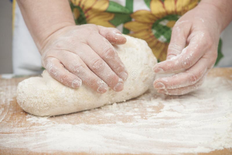 Women's hands preparing fresh yeast dough on wooden table. Raw fresh yeast dough stock images, royalty-free photos and pictures