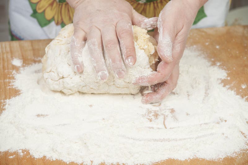 Women's hands preparing fresh yeast dough on wooden table. Raw fresh yeast dough stock images, royalty-free photos and pictures