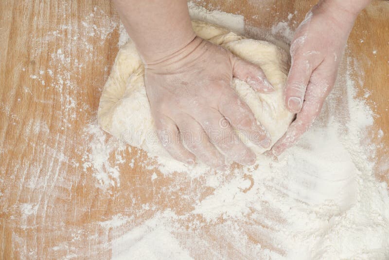 Women's hands preparing fresh yeast dough on wooden table. Raw fresh yeast dough stock images, royalty-free photos and pictures