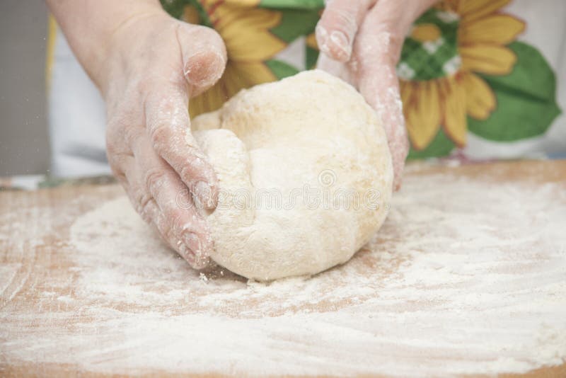 Women's hands preparing fresh yeast dough on wooden table. Raw fresh yeast dough stock images, royalty-free photos and pictures