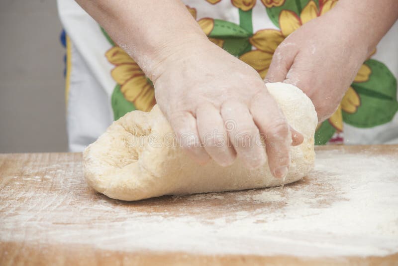 Women's hands preparing fresh yeast dough on wooden table. Raw fresh yeast dough stock images, royalty-free photos and pictures