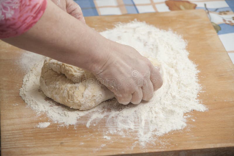 Women's hands preparing fresh yeast dough on wooden table. Raw fresh yeast dough stock images, royalty-free photos and pictures
