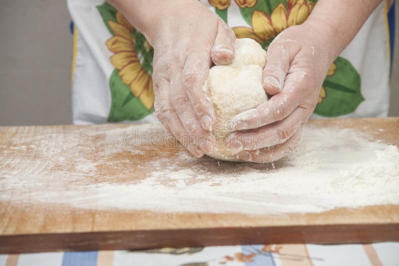 Women's hands preparing fresh yeast dough on wooden table. Raw fresh yeast dough stock images, royalty-free photos and pictures