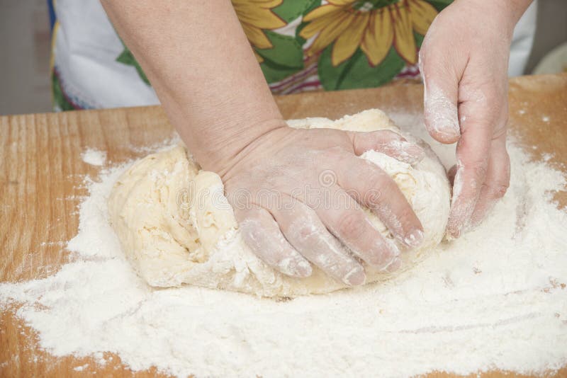 Women's hands preparing fresh yeast dough on wooden table. Raw fresh yeast dough stock images, royalty-free photos and pictures