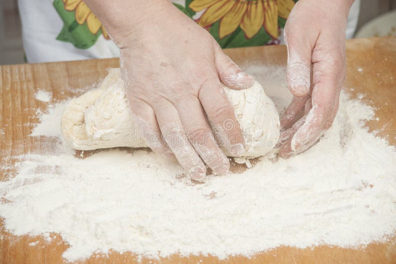 Women's hands preparing fresh yeast dough on wooden table. Raw fresh yeast dough stock images, royalty-free photos and pictures