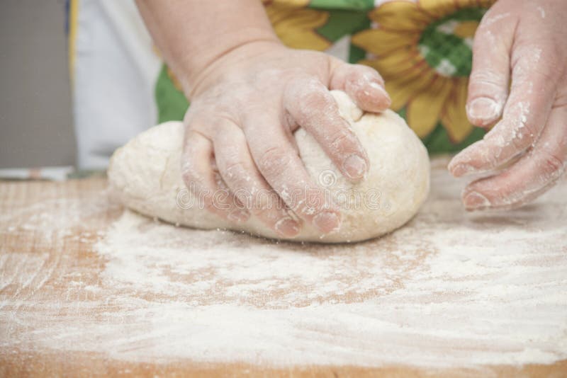 Women's hands preparing fresh yeast dough on wooden table. Raw fresh yeast dough stock images, royalty-free photos and pictures