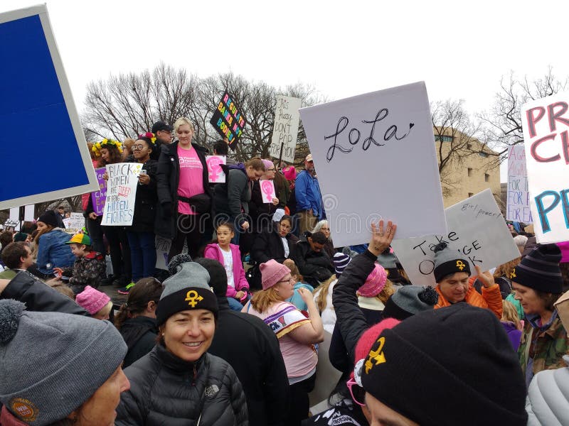 Women`s March on Washington, January 21, 2017: A record number of demonstrators descended on the nation`s capital to rally against the recently-inaugurated President of the United States, Donald Trump. This worldwide, grassroots movement was a series of political rallies organized for women`s rights as well as a myriad of other causes threatened by President Donald Trump`s rhetoric. This photo, taken during the rally, highlights the density of the crowd. Several activists hold signs. There is also a group of woman wearing matching hats embroidered with the Venus female gender symbol. Women`s March on Washington, January 21, 2017: A record number of demonstrators descended on the nation`s capital to rally against the recently-inaugurated President of the United States, Donald Trump. This worldwide, grassroots movement was a series of political rallies organized for women`s rights as well as a myriad of other causes threatened by President Donald Trump`s rhetoric. This photo, taken during the rally, highlights the density of the crowd. Several activists hold signs. There is also a group of woman wearing matching hats embroidered with the Venus female gender symbol.