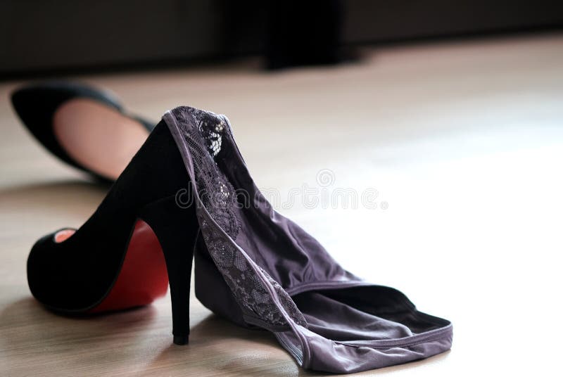 Women`s Underwear Laying On The Floor With Black Heels Bedroom
