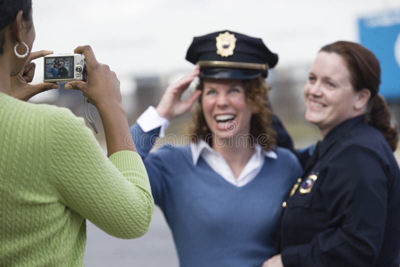 Women sharing uniform for a snapshot.