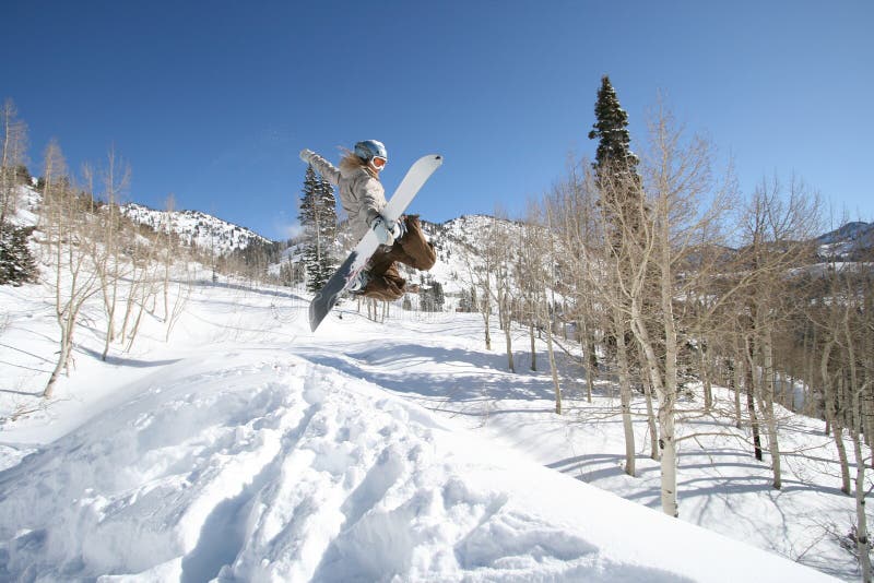 Women snow boarder hits jump 2 in action