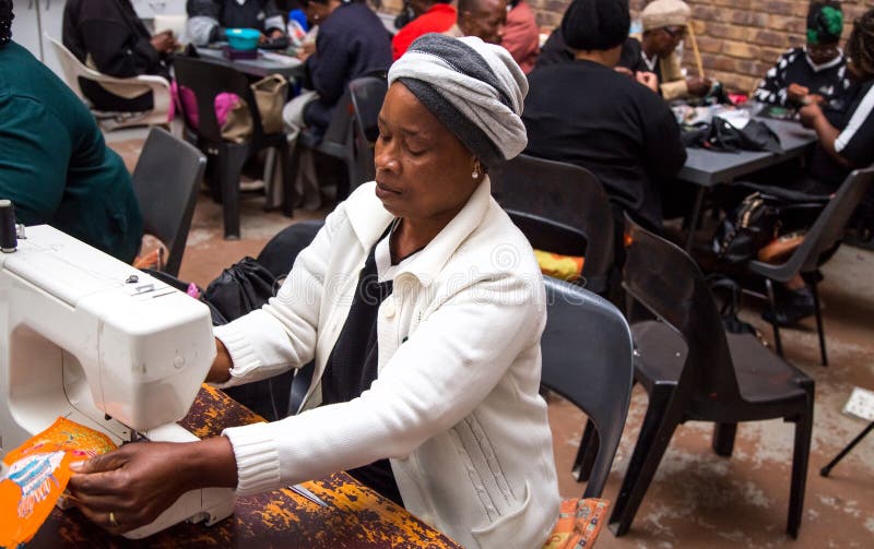 Women sowing with a sewing machine.