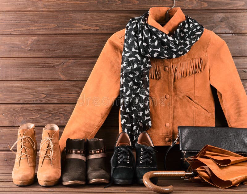 Women's clothing and accessories. Brown suede jacket, three different pairs of shoes, scarf, umbrella and black leather bag. Women's clothing and accessories. Brown suede jacket, three different pairs of shoes, scarf, umbrella and black leather bag