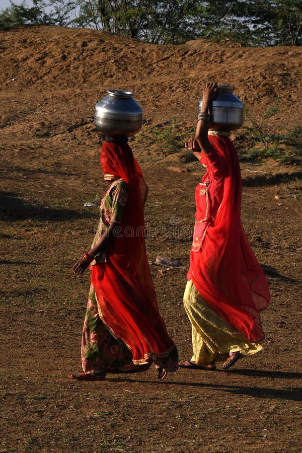 Women taking water at Sand Dunes Khuri, Sam, Jaiselmer, India stock photo