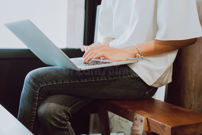 Women are using a computer to work out in the coffee shop. The concept of working anywhere with modern technology