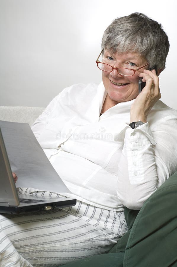 Women is working on laptop and calling by phone