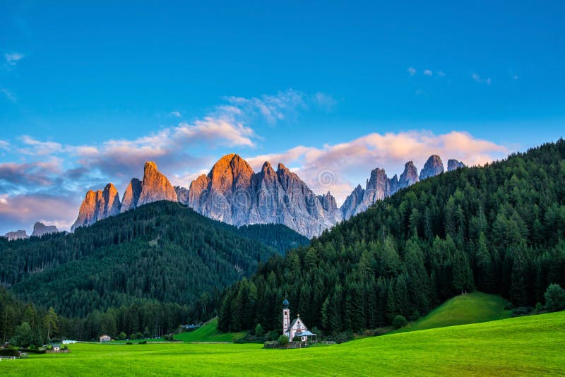 Wonderful landscape of Dolomite Alps during sunset. St Johann Church, Santa Maddalena, Val Di Funes, Dolomites, Italy. Amazing nature background. Artistic picture. Beauty world