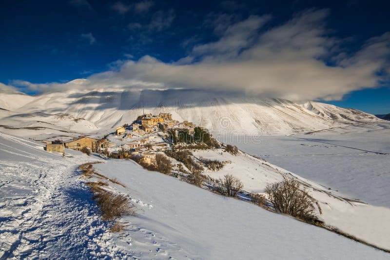 Wonderful and panoramic view of Castelluccio di Norcia village with snow in the winter season, Umbria