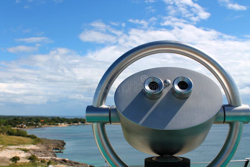 A modern fixed binoculars with a wonderful overview of the caribbean island near the city La Romana, dominican republic. A modern fixed binoculars with a wonderful overview of the caribbean island near the city La Romana, dominican republic