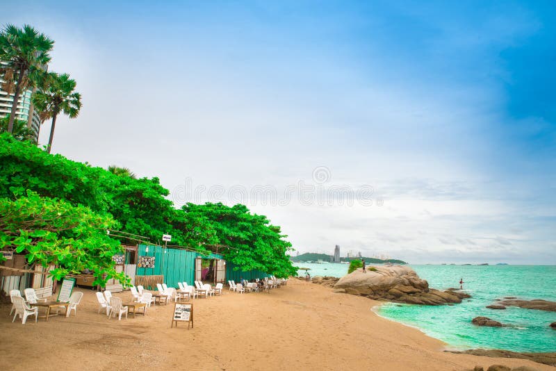 PATTAYA, THAILAND - JUNE 4, 2022. Wong Amat Beach. landscape of the beach with a green vegetation and restaurant, turquoise sea against the blue sky. PATTAYA, THAILAND - JUNE 4, 2022. Wong Amat Beach. landscape of the beach with a green vegetation and restaurant, turquoise sea against the blue sky