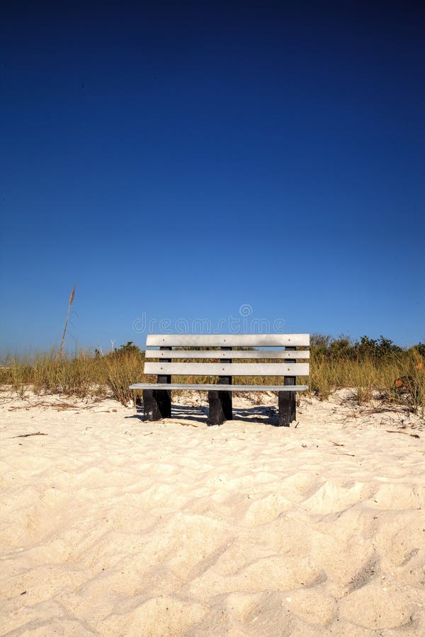 Wood bench on the white sand beach of Delnor-Wiggins Pass State