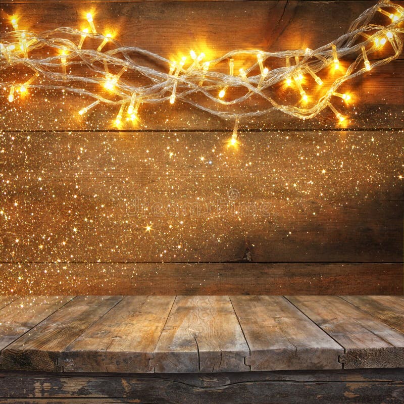 Wood Board Table In Front Of Christmas Warm Gold Garland ...