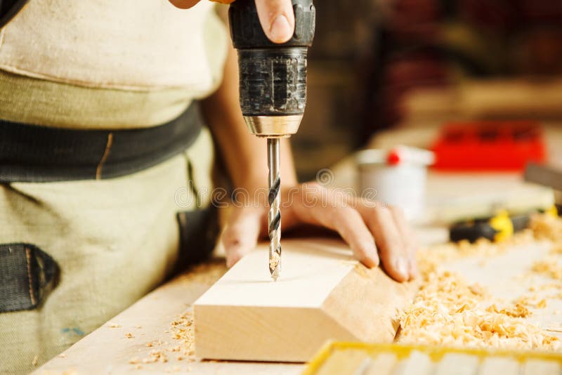 Wood Boring Drill In Hand Drilling Hole In Wooden Bar 