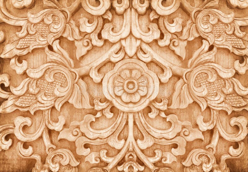Wood carving texture in flower shaped patterns brown background