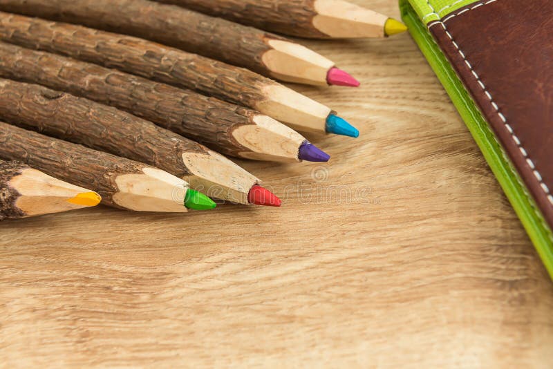 Wood colored natural pencils and leather notebook royalty free stock images