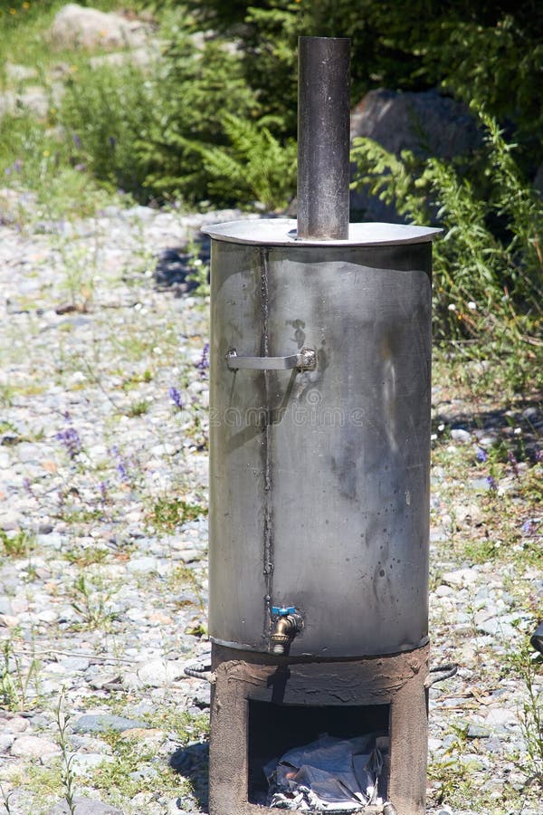 Woodfired Water Heater for Boiling Water during Camping Stock Image