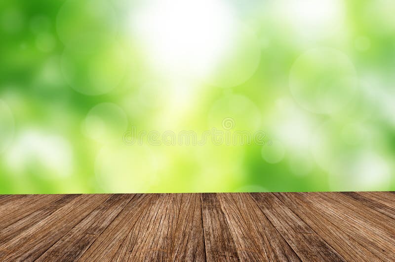 Wood floor over green forest bokeh background stock photos