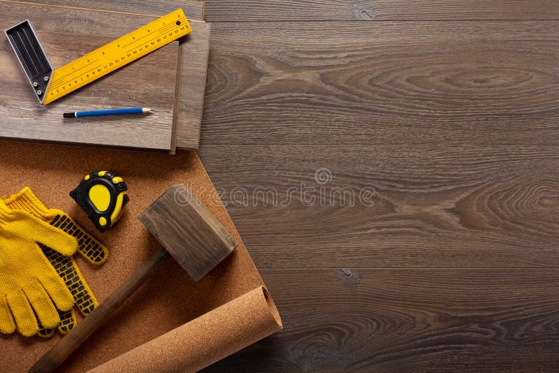 Wood laminate floor and tools background texture. Wooden laminate