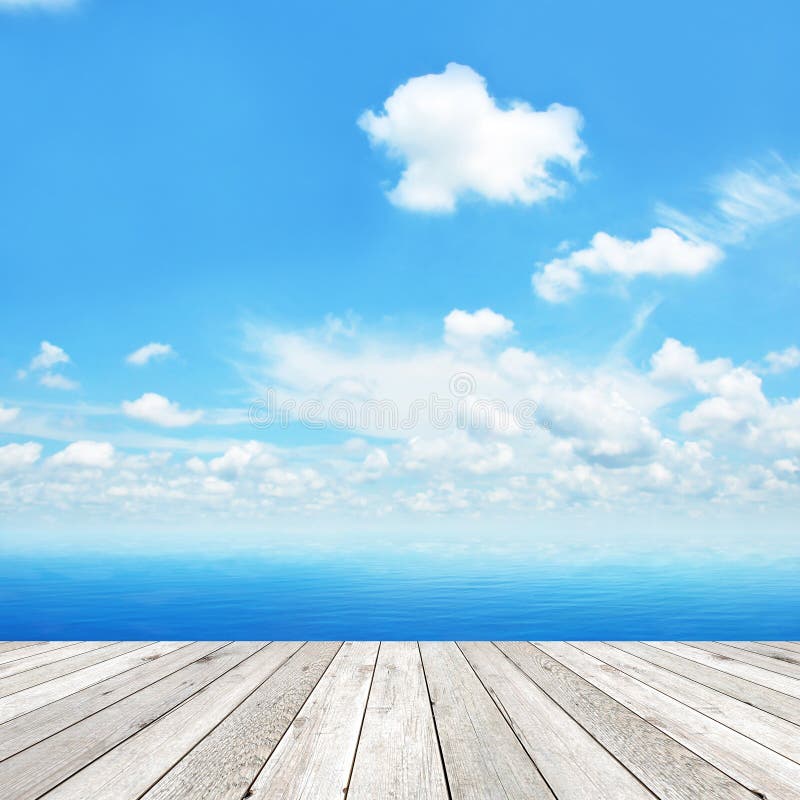 Wood plank as a pier on blue sea & sky background