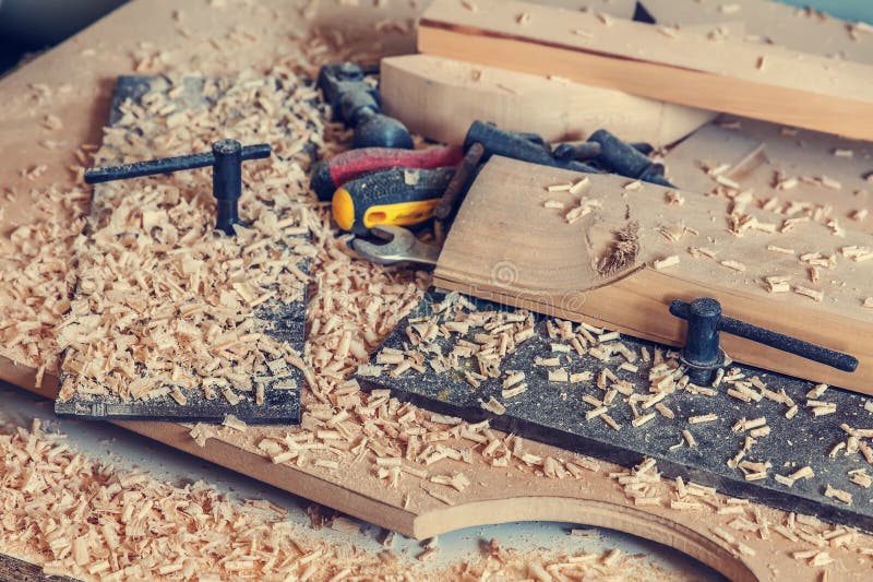 Wood processing. Joinery work. wood carving. a wooden shavings, tools on the wooden background close up. use as background