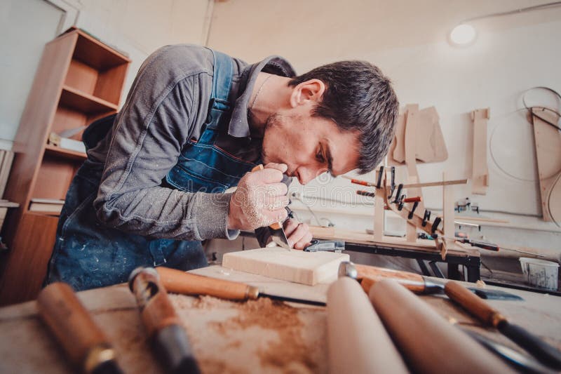 Wood processing. Joinery work. wood carving. The carpenter uses a cutting knife for framing