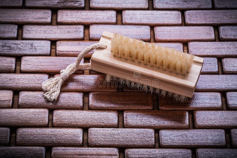 Wood scrubbing brush on textured table wooden mat top view healt