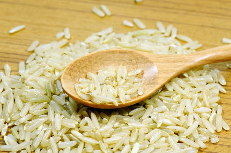 Wood spoon and brown rice. stock image. Image of rice 30444027
