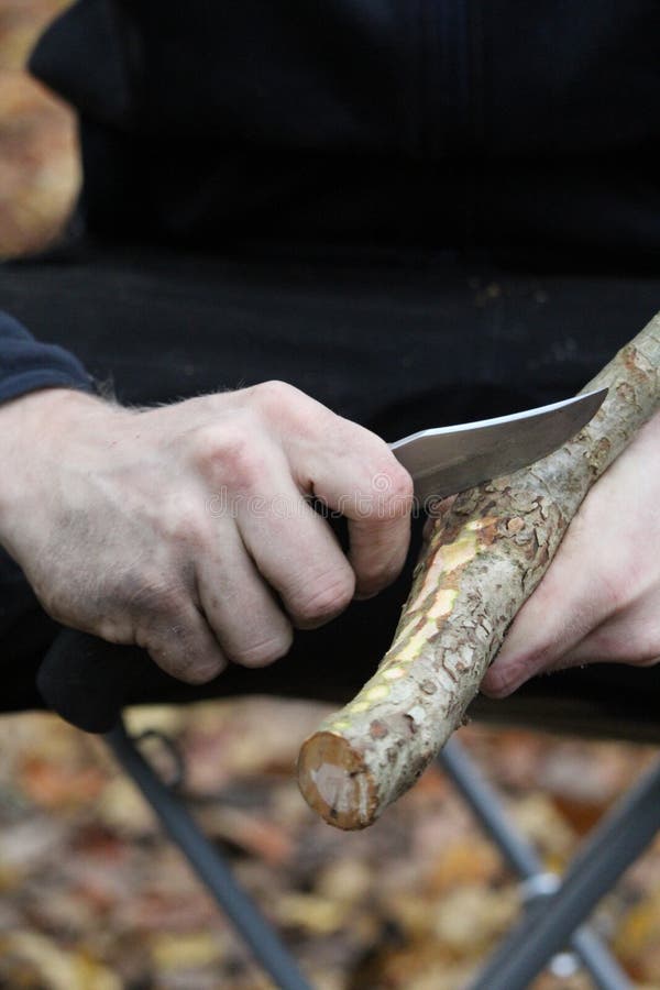 Wood stick and knife stock image. Image of finger, hand 263675569
