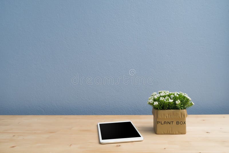 Wood table with blank screen smartphone and dwarf tree on flower pot. royalty free stock images Wood table with blank screen smartphone and dwarf tree on flower pot. royalty free stock images