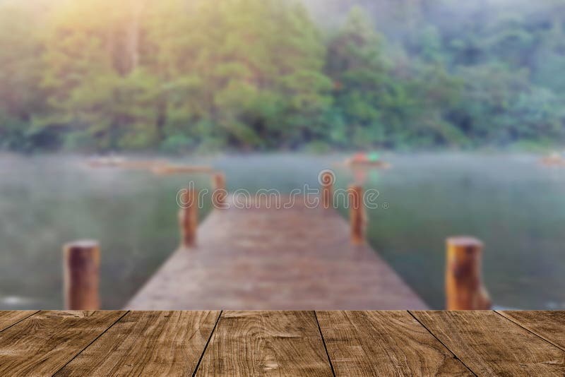 Wood table with blur wood bridge dock lake travel background royalty free stock photo Wood table with blur wood bridge dock lake travel background royalty free stock photo