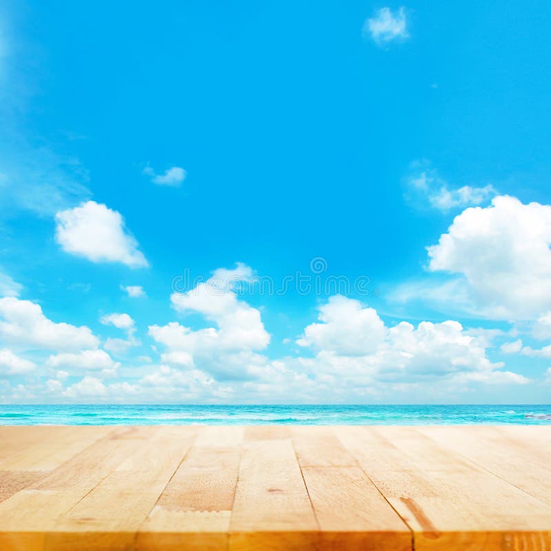 Wood table top on blue sea & sky background