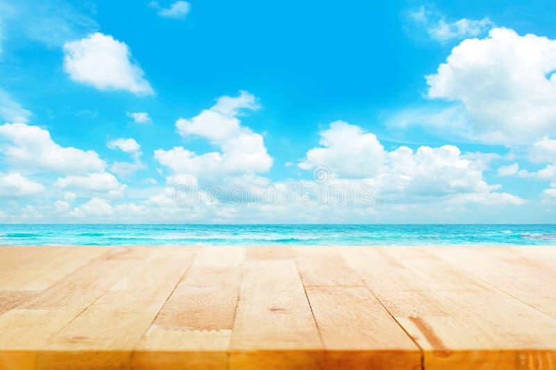 Wood table top on blue sea & sky background
