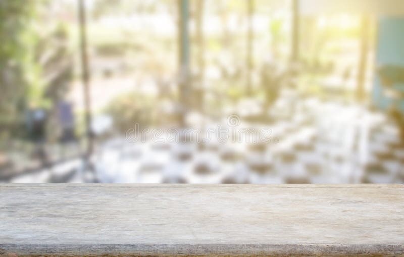 Wood table top on blur coffee shop or kitchen window background royalty free stock photography Wood table top on blur coffee shop or kitchen window background royalty free stock photography