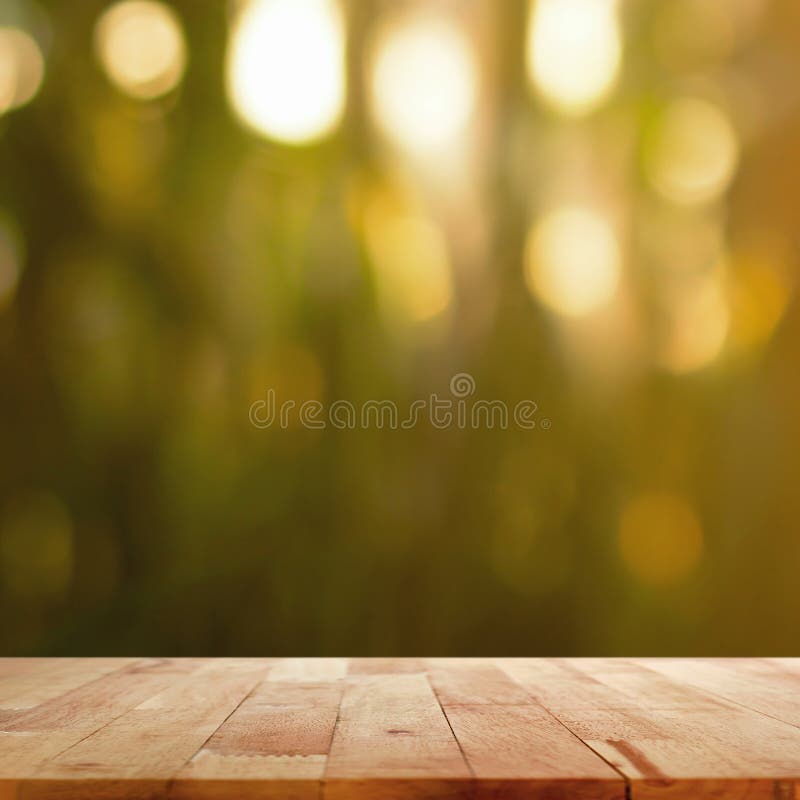 Wood table top on blur dark green background with bokeh effect royalty free stock photos