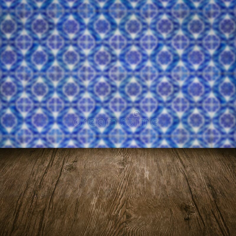 Wood Table Top and Blur Vintage Ceramic Tile Pattern Wall Stock Photo