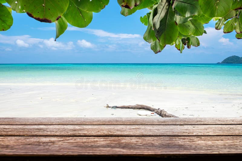 Wood table top on sea beach colorful white sand