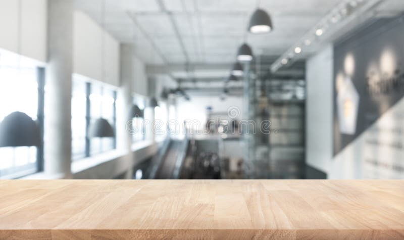 Wood table top texture on blur modern/contemporary building hall